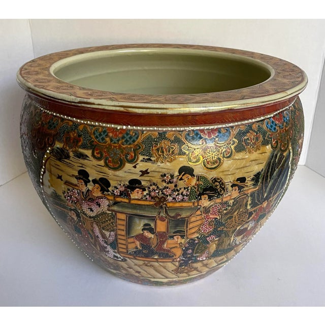 Here is a stunning Japanese Satsuma fishbowl vessel featuring hand-painted scenes of Geishas, gardens and birds. The...