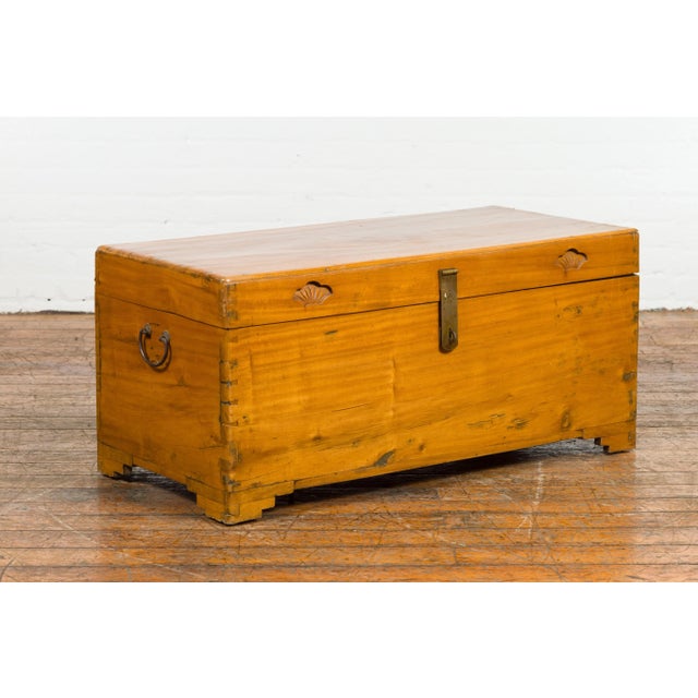 A vintage Chinese blanket chest from the mid 20th century with carved seashell motifs, dovetail construction in the...