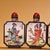 This is a set of four matching cloisonné enamel snuff bottles, each featuring a hand-painted portrait of one of the "Four...