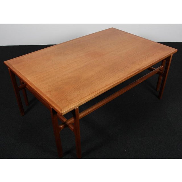 Ole Wanscher coffee table of mahogany. Made by A. J. Iversen. This piece is attributed to the mentioned designer/maker. It...