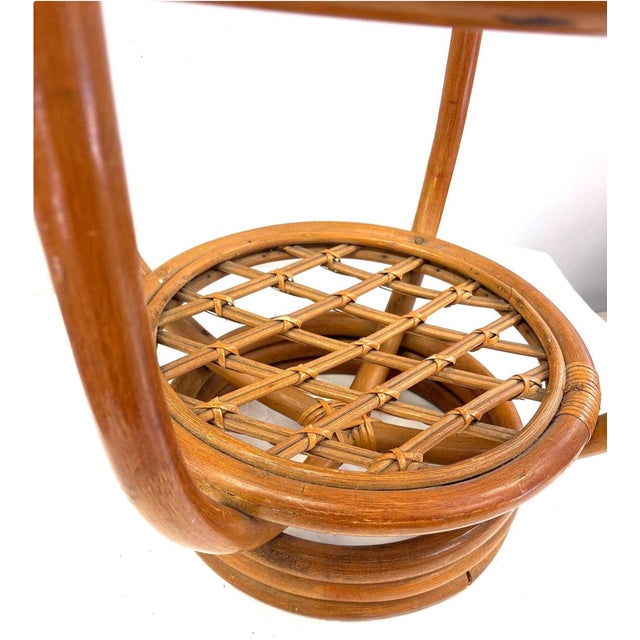 Vintage bent rattan side table with round glass top, woven lattice lower shelf, and stacked coil base. Wrapped joints. 20"...