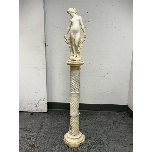 Design Plus Gallery presents a Set of Female Sculpture in Alabaster by Emilio Fiaschi on a Marble Pedestal Stand. Emilio...
