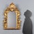 Baroque mirror in carved and gilded wood, dating back to the early 19th century, originating from Italy. The meticulously...