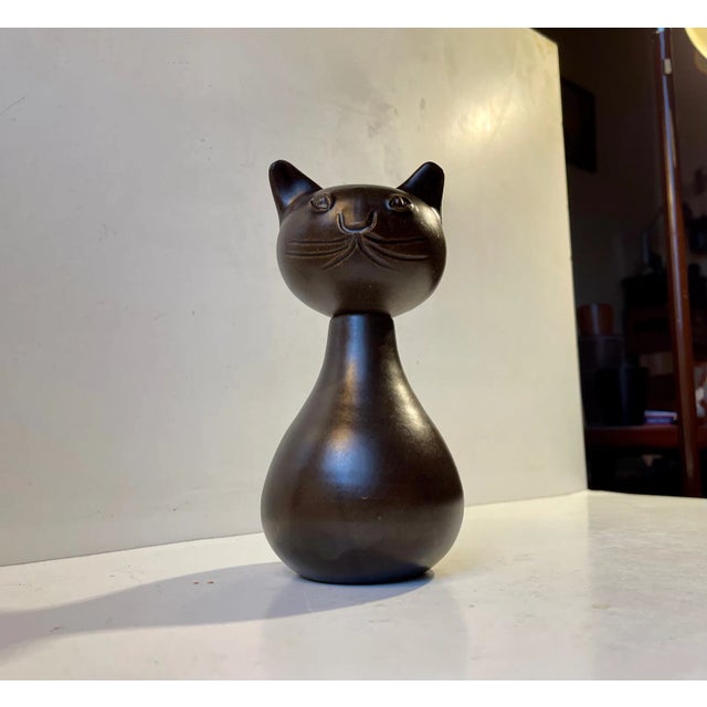 Unusual piece unique from the danish ceramist bjerre. A dark brown glazed ceramic cat that is intended as a...