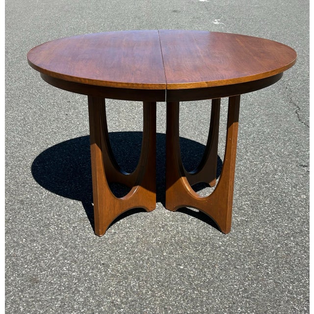 An absolutely wonderful mid century modern model no. 6140-45 walnut dining table with three 12-inch leaves from the...
