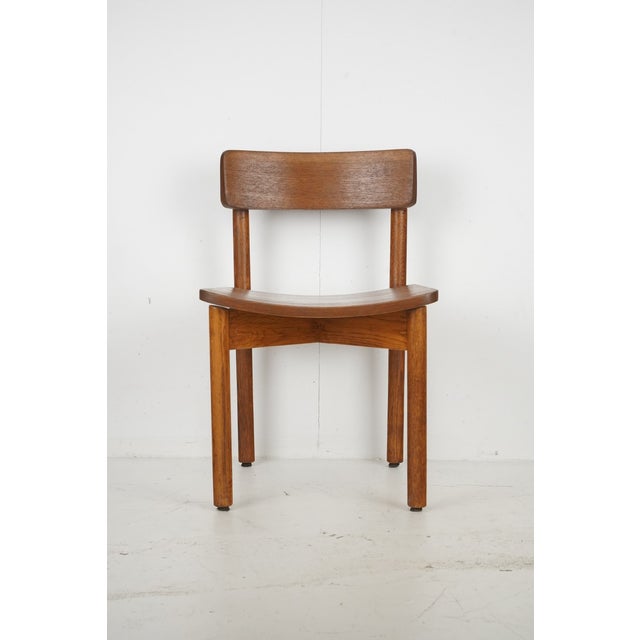 Vintage Mid Century Modern dining chair made of oak with a wide curved backrest and seat, and cylindrical shaped legs....
