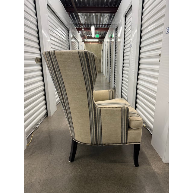 Classic elegance meets everyday comfort in this Williams Sonoma Home “Chelsea” wingback chair. Upholstered in a refined...