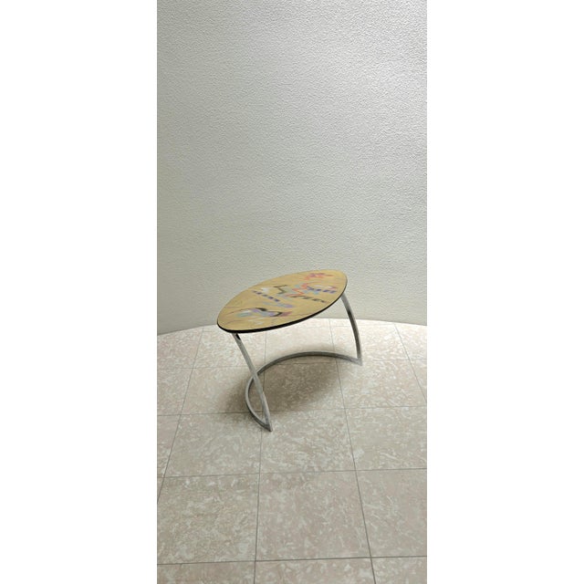 Carlo Malnati painterly wood table in a matte metallic gold. A rainbow of colors produce a besutiful abstract design...