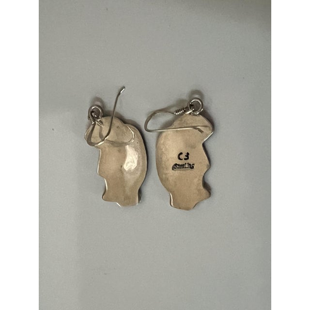 Native American-style earrings featuring a Kokopelli design, crafted from sterling silver. Kokopelli is a revered figure...