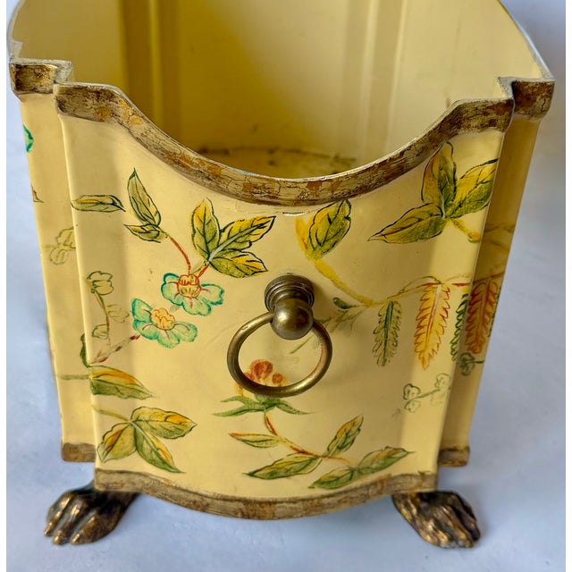 Vintage hand-painted bird and floral tole cachepot with bronze claw feet and ring side handles. Depicts various hand-...
