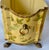 Vintage hand-painted bird and floral tole cachepot with bronze claw feet and ring side handles. Depicts various hand-...