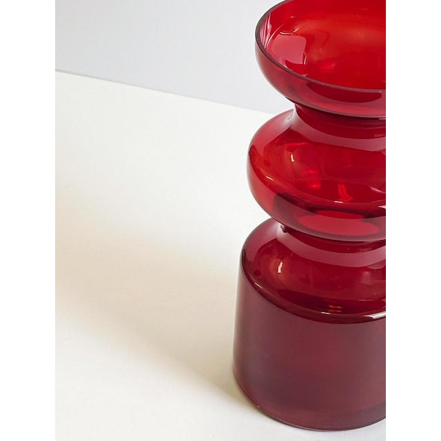 A 1960s red art glass vase designed by Per-Olof Ström for Alsterfors Glasbruk, Sweden. Executed in the sommerso technique,...