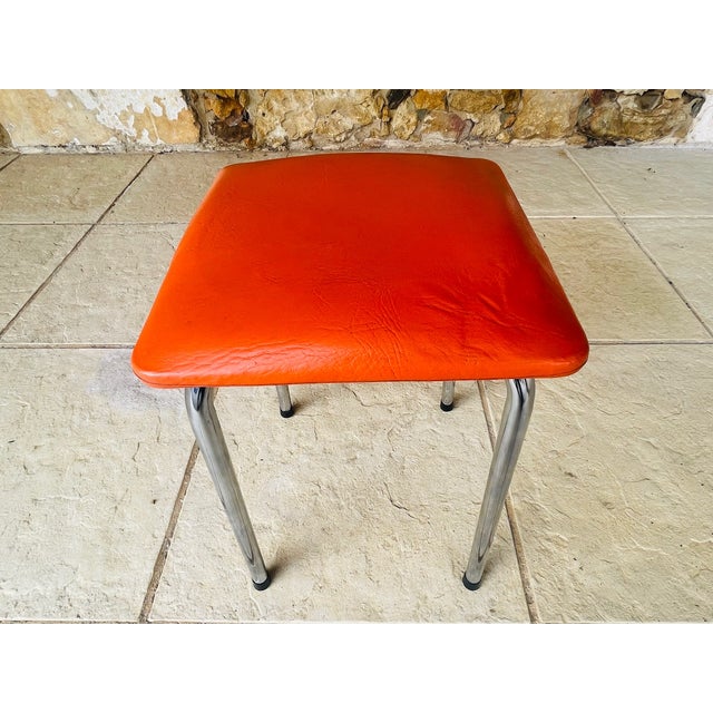 Mid century, skaï/ leatherette/vinyl and chrome stool circa 70s top of toll has an orange textured color skaï finish. legs...