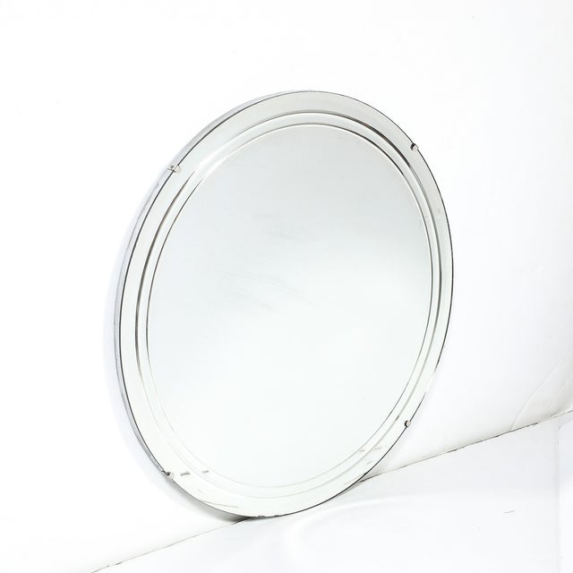 This Art Deco streamlined round mirror, crafted in America circa 1935, is a refined example of the Machine Age's...