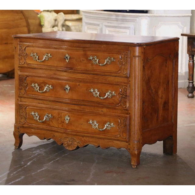 This elegant antique chest of drawers was crafted in Lyon, France, circa 1760. Built of elm and chestnut wood, the large...