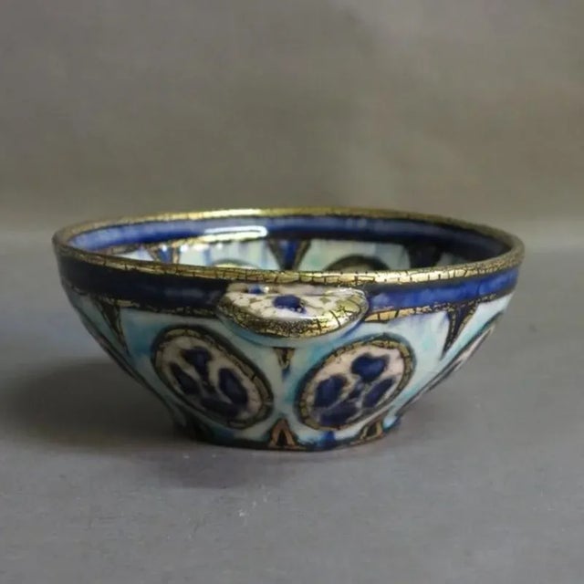 This Jugendstil ceramic bowl is hand painted in different colors and has gold decoration. It was designed by Andre Métthey...