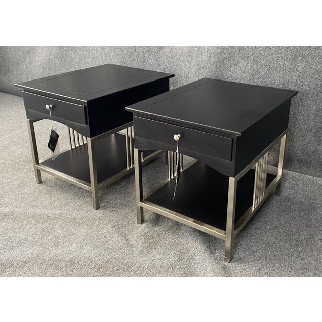 This pair of Stanley side tables features sleek black tops paired with brushed stainless steel bases for a clean, modern...