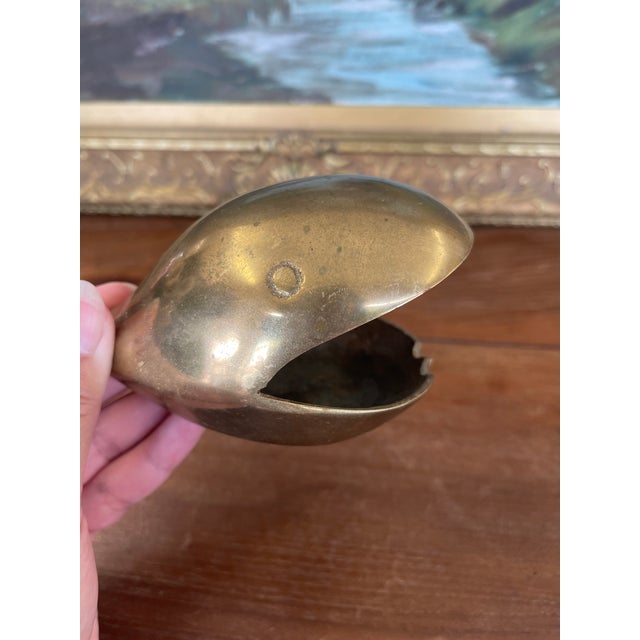 This charming mid-20th century solid brass whale sculpture serves as both a whimsical decorative accent and a functional...