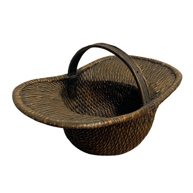 Vintage handwoven gathering basket crafted from split reed with a pronounced wide rim and integrated arched handle. The...