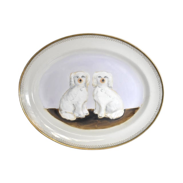 A portrait of an antique pair of Victorian English Staffordshire spaniel dogs, white with gold gilt details; painted in...