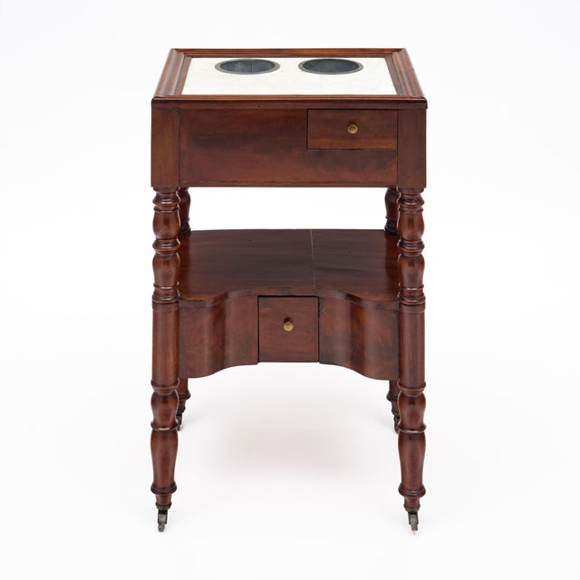 Rafraichissoir table from France in the Louis XVI style. This beautiful antique side table features two metal bucket...