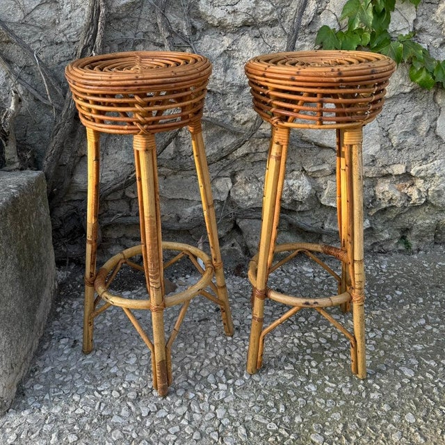 Pair of French mid century rattan barstools. Solid condition. 12”dia x 29”h 45-010