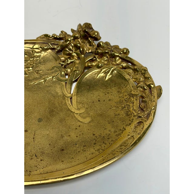 Lovely Art Nouveau brass trinket tray featuring raised flowers and swirling vines. Signature 'Aug. Aro...?" toward edge of...