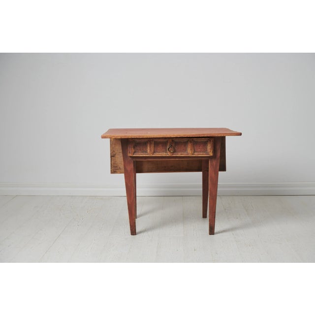 Small charming country table from northern Sweden. The table is a genuine folk art furniture from around 1790 to 1810. It...