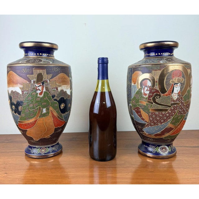 Pair of Japanese satsuma porcelain vases circa 1900-1920. Polychrome decoration of animated scenes with gold highlights....