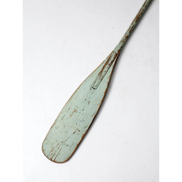 This is a vintage painted wooden oar. The classic canoe oar features beautifully aged seafoam green paint. A marvelous...