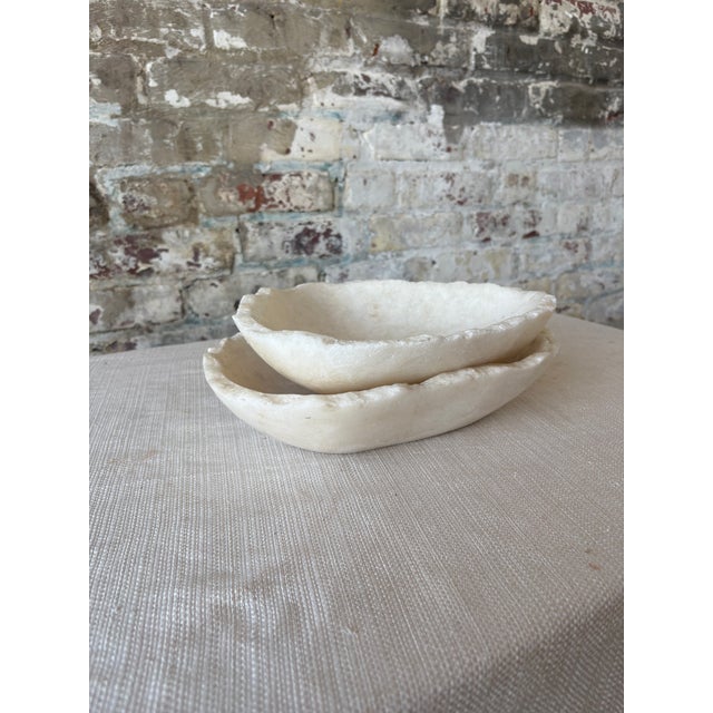 Beautiful raw white onyx bowls, each carved from natural stone and showcasing the unique veining, tonal variation, and...