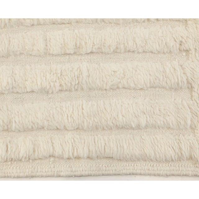 This modern Moroccan rug exemplifies the soulful minimalism and tactile luxury of contemporary Berber design. Hand-knotted...