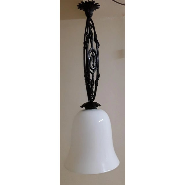 French Art Deco Ceiling Lamp from the 1930s with a Forged Frame Made of Iron and Brass, Painted Black, and a White Opaque...