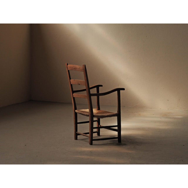 Folk armchair from the Cantal, dating from around 1900, with a solid wood frame, woven rush seat, and tall two-bar...