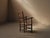 Folk armchair from the Cantal, dating from around 1900, with a solid wood frame, woven rush seat, and tall two-bar...
