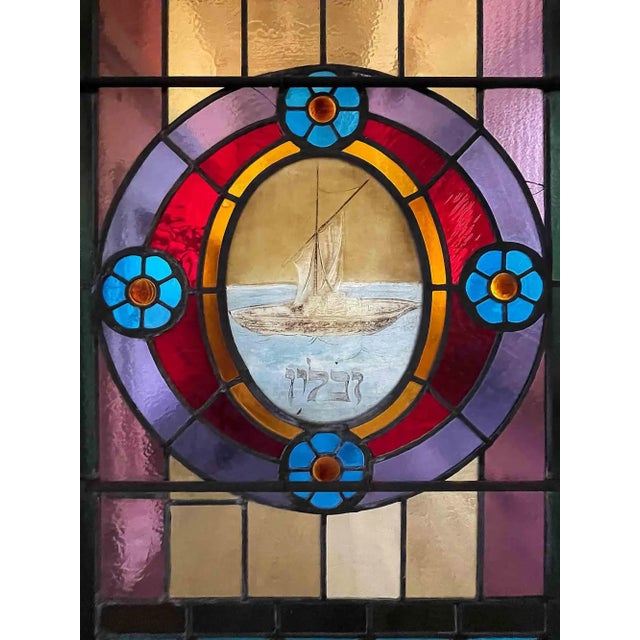 Antique Art Nouveau style leaded and stained glass windows. This arch top, polychrome window has an exuberant design of...