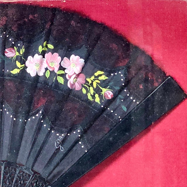 The fan as artform. Its hand-painted flowers rest delicately on black lace, framed in gilded gold gesso. It is elegance...