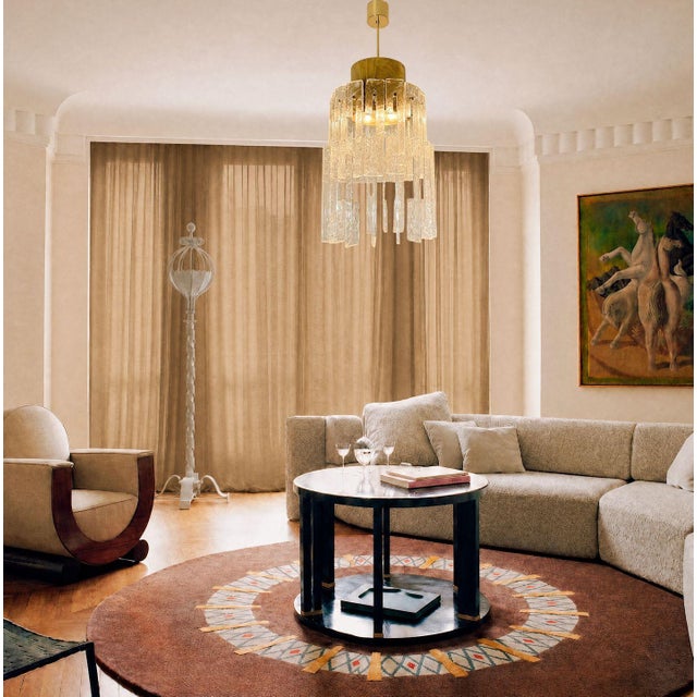 Mid-Century Modern brass and clear Murano glass pendant chandelier, attributed to Mazzega Italy 1970s The brass frame is...