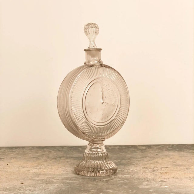 A 19th Century bottle with the face of a clock.