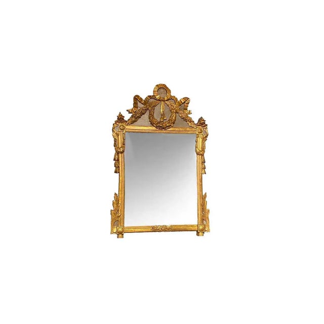 A Louis XVI period gilt wood and polychrome French provincial mirror depicting flowers around frame with bow draped across...