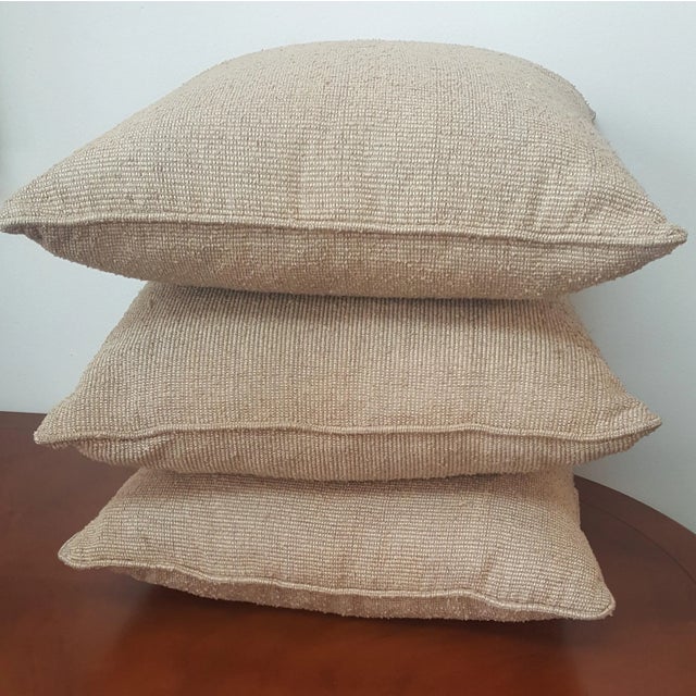 Set of 3 standard throw pillows in a taupe, beige tight woven pattern. Matching pillows. Showroom sample.