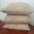 Set of 3 standard throw pillows in a taupe, beige tight woven pattern. Matching pillows. Showroom sample.