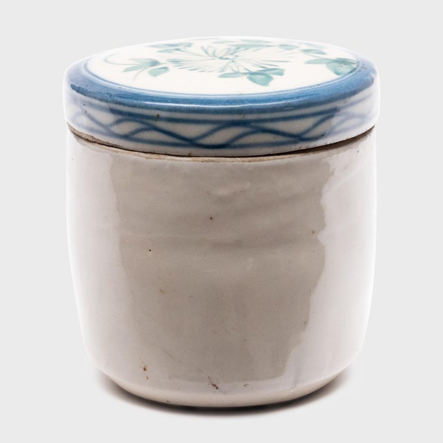 Used to store loose leaf tea, this small ceramic jar from the late 19th century is sparsely glazed in the classic blue-...