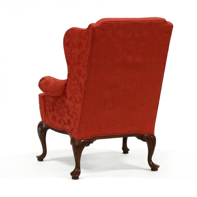 Late 20th century, cherry red damask upholstery, loose seat cushion, cabriole legs with scrolled carved knee, labeled