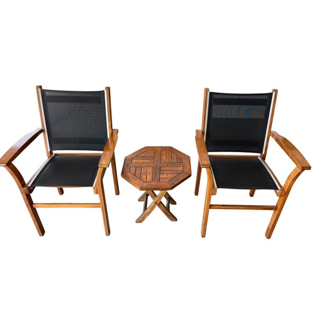 A well-made pair of vintage patio lounge chairs by Robb & Stucky, executed in solid teak with black mesh sling seats and...
