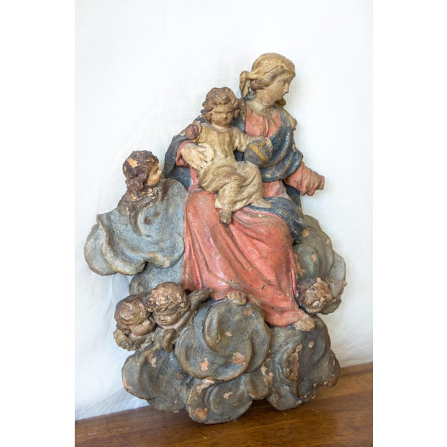 France Terracotta wall lamp, representing the Virgin and Child surrounded by cherubs, 18th century Wear and lack...