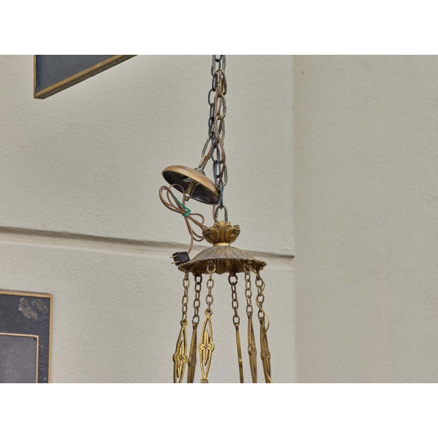 A refined 19th-century French chandelier combining neoclassical form with the luminous beauty of alabaster. The circular...