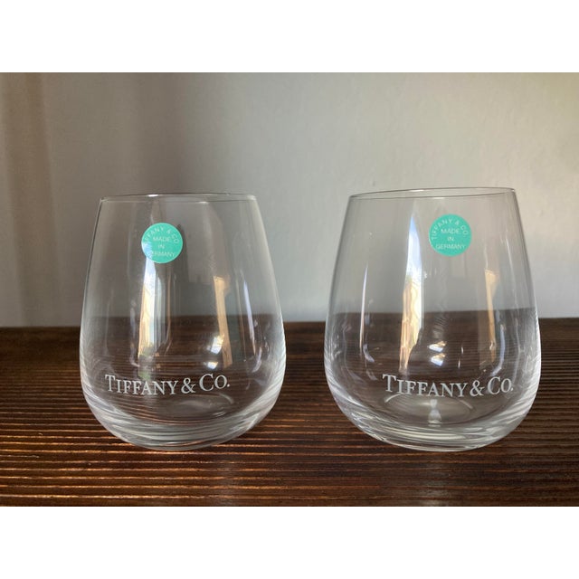 A beautiful set of two Tiffany & Co. stemless wine glasses, presented in their original Tiffany-blue gift box. These...