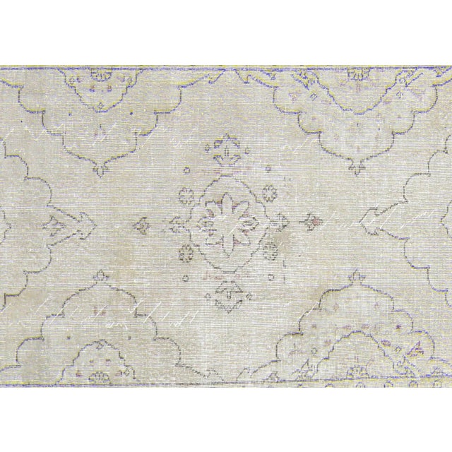 A vintage Turkish Oushak measuring 4'8" x 13'3", hand-woven with wool on wool foundation. This piece displays the region's...