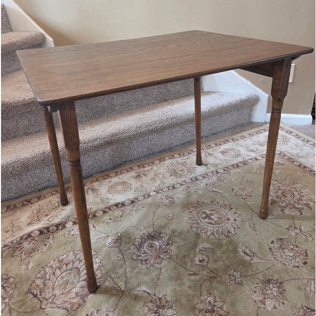 This is an antique folding table. The table features legs that fold in with a wooden "Clipper" style latch for easy...